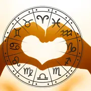 Manos formando un corazón ante la rueda zodiacal de los signos.