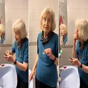 Una mujer maquillándose en el espejo de su casa