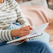 Foto de mujer escribiendo una agenda.