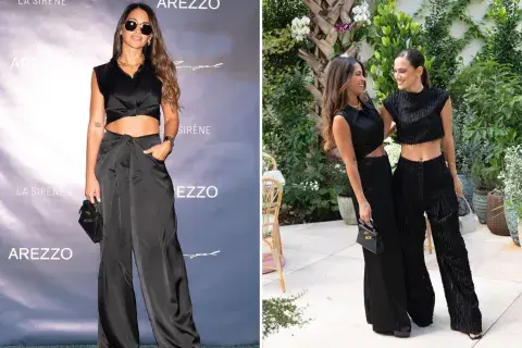 En total black, el crop top y pantalón en conjunto combinan con un estilo de nudo que le da un toque fashionista. En total black, el crop top y pantalón en conjunto combinan con un estilo de nudo que le da un toque fashionista.