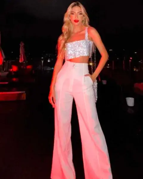 Con un pantalón blanco bien al cuerpo (que después se abre), el crop top plateado es el detalle que eleva el look. Con un pantalón blanco bien al cuerpo (que después se abre), el crop top plateado es el detalle que eleva el look.