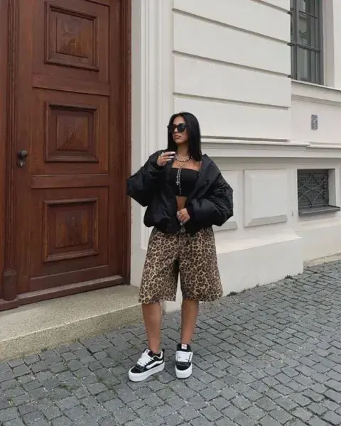 Una mujer en la calle usando bermudas. Una mujer en la calle usando bermudas.