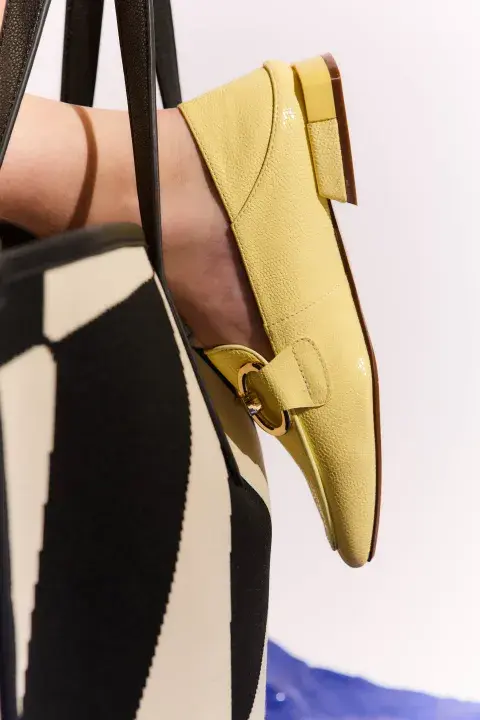 Foto de un pie con un mocasín amarillo. Foto de un pie con un mocasín amarillo.