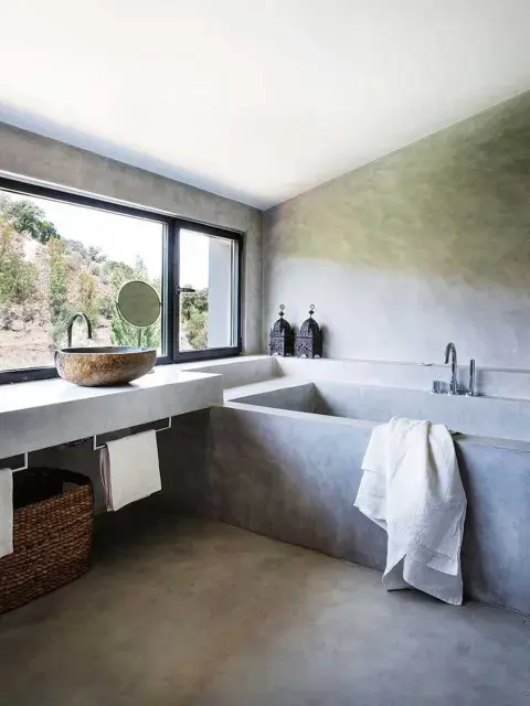 En primer lugar, una bañera de microcemento, en un baño moderno con aberturas en color negro En primer lugar, una bañera de microcemento, en un baño moderno con aberturas en color negro