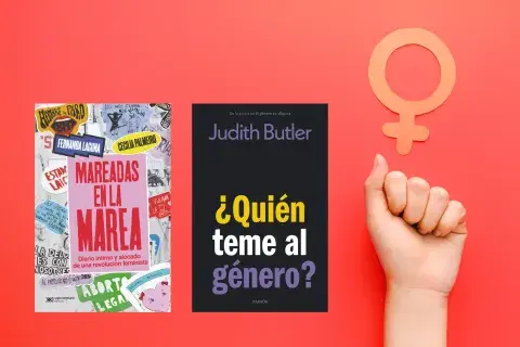 Un puño levantado y el símbolo del feminismo Un puño levantado y el símbolo del feminismo