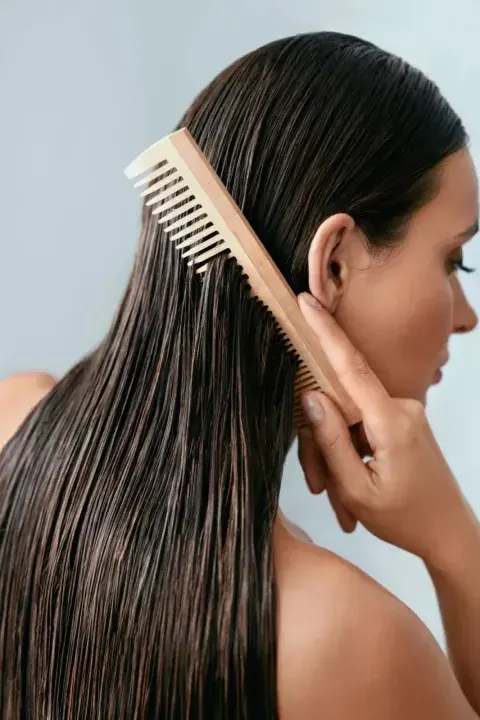 una mujer cepillandose el pelo una mujer cepillandose el pelo