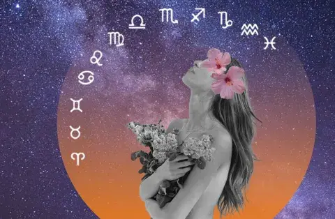una mujer con flores mirando los signos del zodíaco