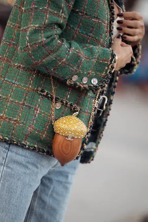 Una mujer con un look de Street style durante parís Fashion Week con bolso muy original Una mujer con un look de Street style durante parís Fashion Week con bolso muy original