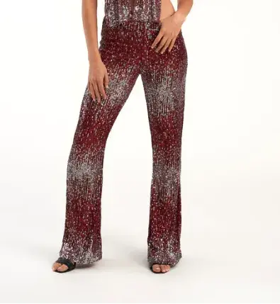 Pantalón de lentejuelas bicolor, Delaostia $132.200