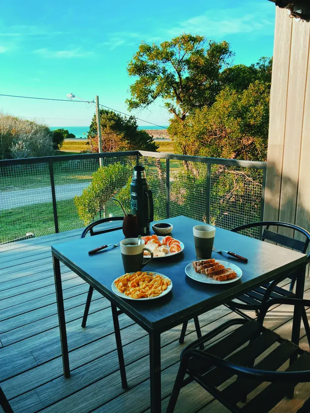 Afuera, el ritual es desayunar mirando el mar. Los muebles de hierro (Easy Argentina) se bancan bien el salitre. 