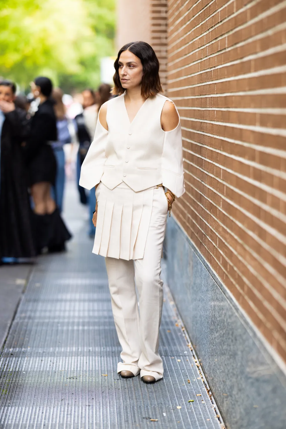 Un look moderno y cool. Total white, lo amamos. Chaleco y falda tablada sobre pantalón. Todo lo que esta bien. 