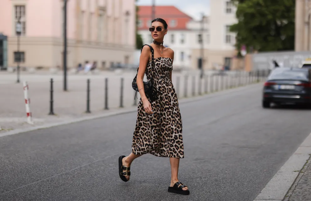 Mujer con vestido animal print caminando por las calles de Paris. 