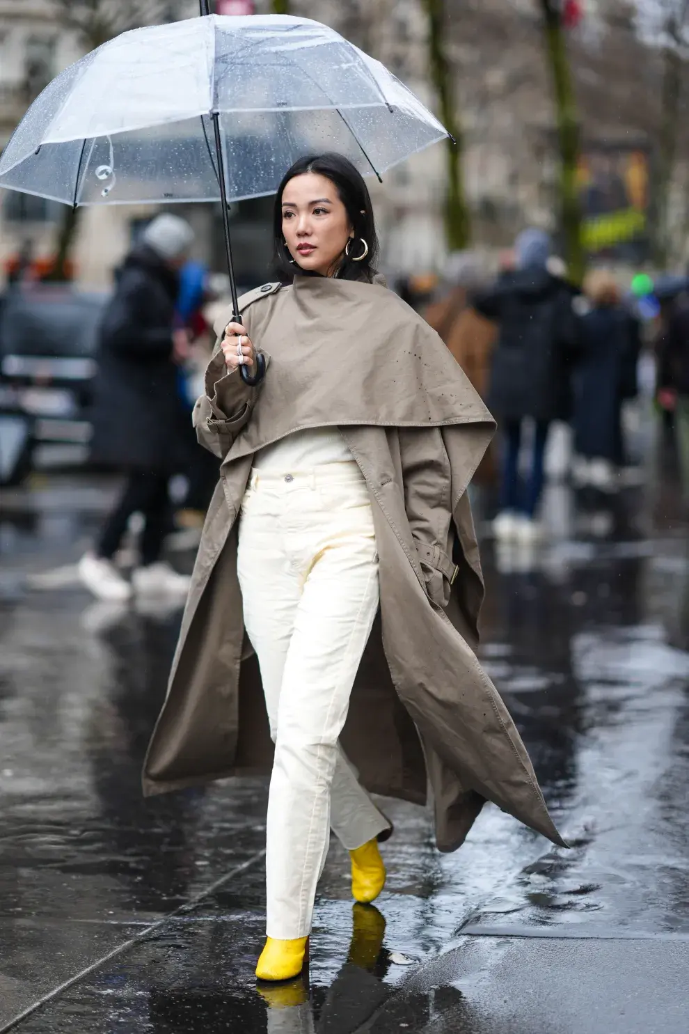 Mujer bajo la lluvia con piloto/capa