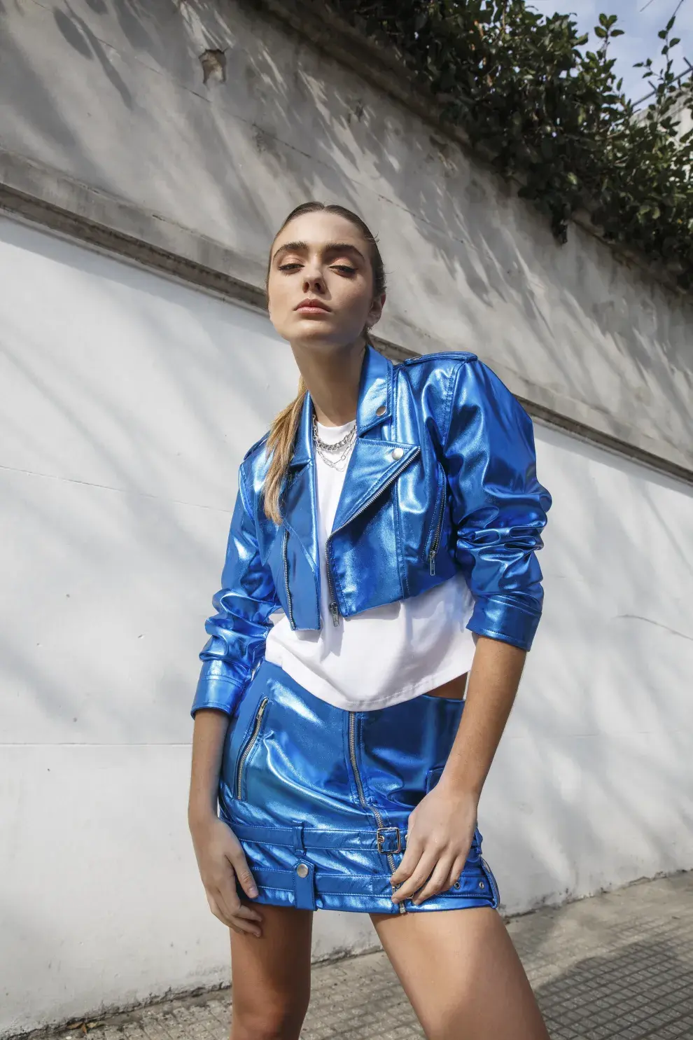 Una mujer posando con un conjunto azul metalizado