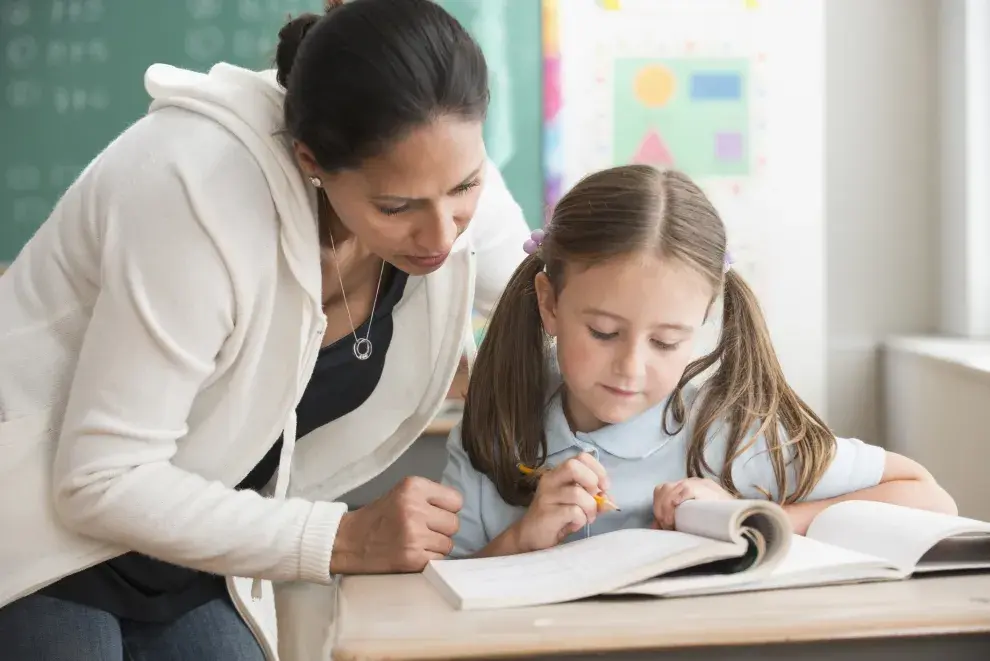 Maestra y alumna estudiando.