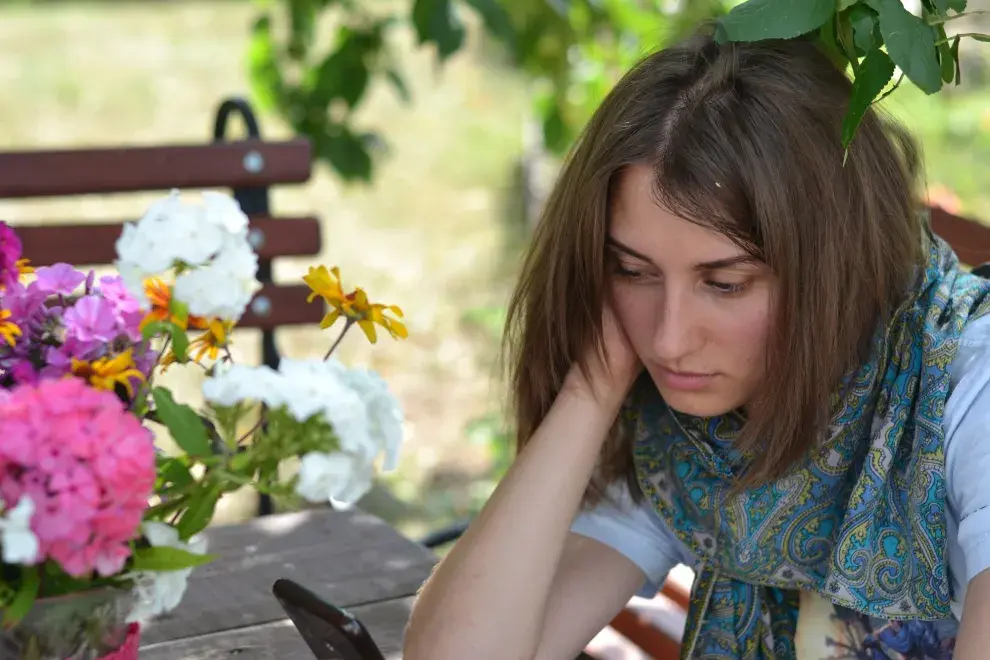 Chica mirando el celular con gesto de desilusión.