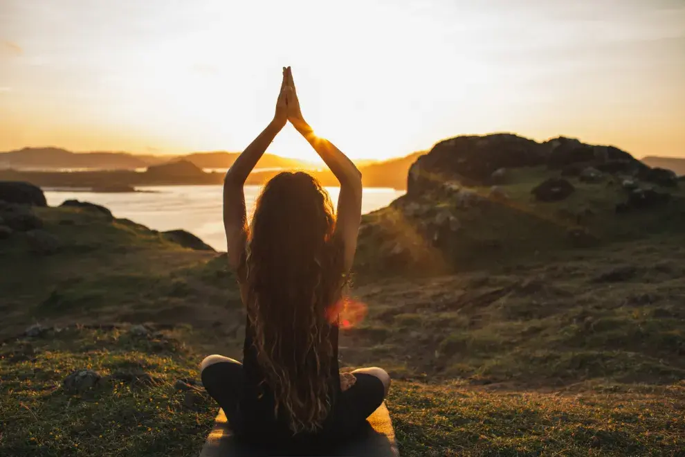 Una mujer haciendo yoga en la naturaleza.