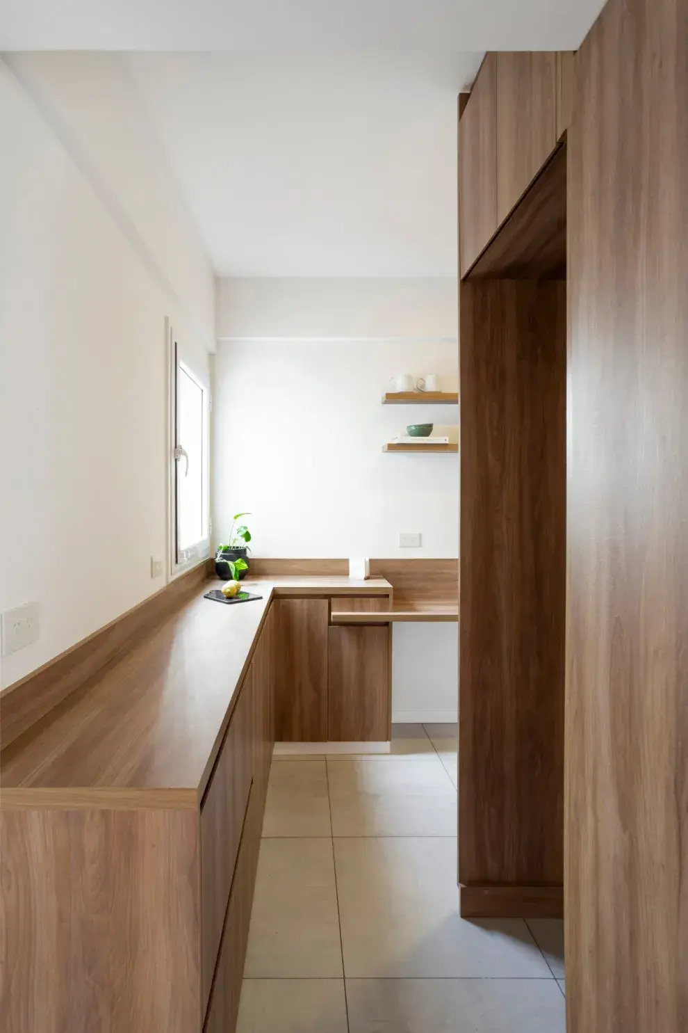 El mueble de guardado también sirve como apoyo para lo que se lleva o se saca de la heladera (a la derecha). Piso de porcelanato 'Life Tiza' de Cerro Negro (Foschia).