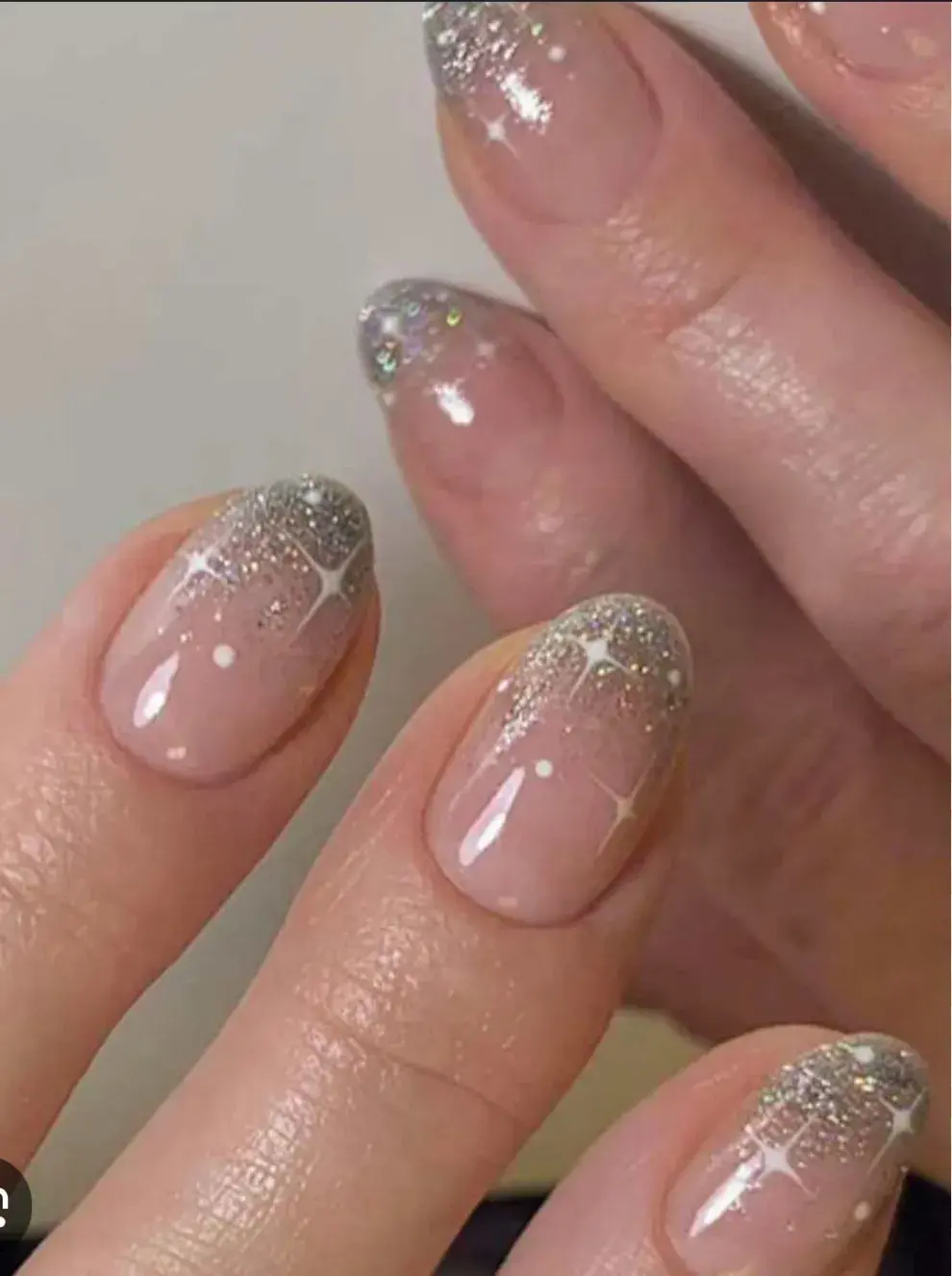 Diseños de uñas cortas para fin de año: French con brillo metálico.