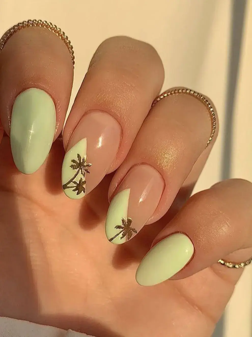 Palmeras, flores mini, hojas y guiños tropicales aparecen en versión micro nail art, sobre bases nude o transparentes.