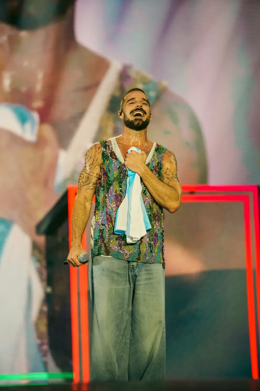 Ricky Martin, sosteniendo una camiseta argentina en el escenario.
