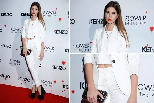 Agustina Cordova, toda de blanco, con un crop top y accesorios en negro, para el evento de Kenzo