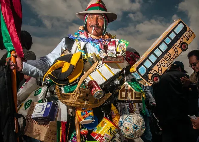 Aquí un hombre disfrazado de ekeko, un amuleto de yeso o arcilla, en forma de figura humana que suele verse sonriente, con los brazos abiertos, al que se atribuye la virtud de propiciar prosperidad y abundancia