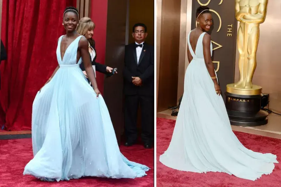 Lupita Nyong''o, con una creación de Prada que hace foco en el escote de frente y de espalda, en un tono celeste. La vincha....mmmm