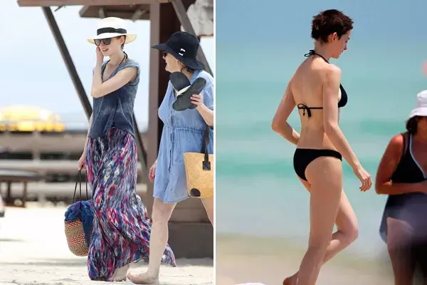 Anne Hathaway llega a la playa con sombrero y vestido largo. Para pasar desapercibida la actriz prefiere un traje de baño en color negro