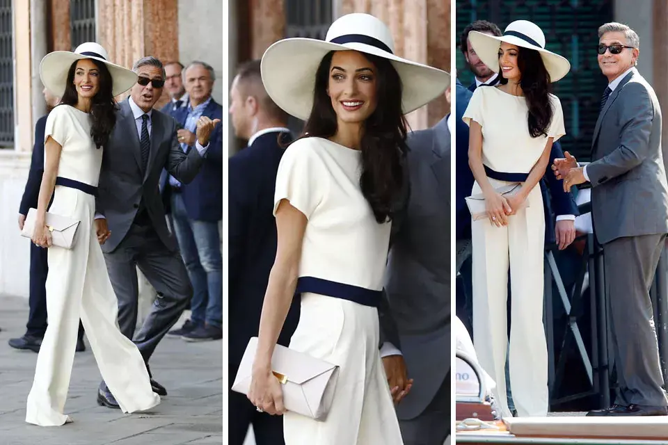 Para la boda civil Amal Alamuddin prefierió un conjunto de top y pantalón blanco con ribetes azules. Lo combinó con una capelina en los mismos tonos  y sobre color nude