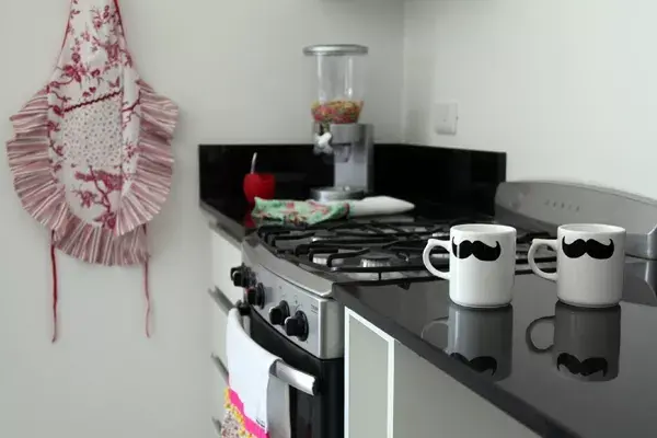 La cocina integrada aporta su cuota de color con sus individuales (desde $28 c/u) y delantal (desde $65, todo Vajillas y Puntadas) con volados, su mate Matteo y su dispenser de cereales ($79 y $273, todo Ominim Sorpresería)
