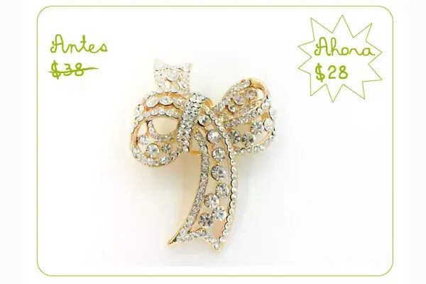 Prendedor con forma de moño dorado con brillantes  (Nina Piu)