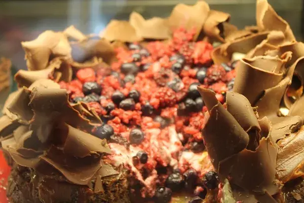 La torta amarga no se queda atrás: base de soufflé de chocolate amargo, dulce de frambuesa, crema y frutos rojos