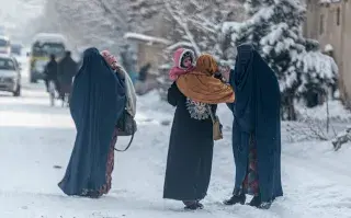 El nuevo Código Penal talibán: más pena por maltratar a un camello que por fracturarle el brazo a una mujer Mujeres afganas vestidas con burka llevan niños mientras caminan por una calle nevada en Kabul .