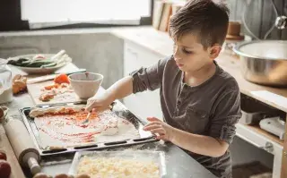 Cómo organizar la comida de los chicos en tiempos de Mundial un nene cocina pizza