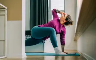 Por qué agosto es el mes ideal para empezar una nueva rutina de ejercicio mujer hace ejercicio en su casa