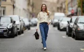 Una mujer caminando por la calle con un jean recto